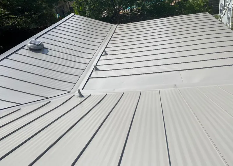 Solar attic fan installed on a metal roof for Roof Ventilation in Roswell